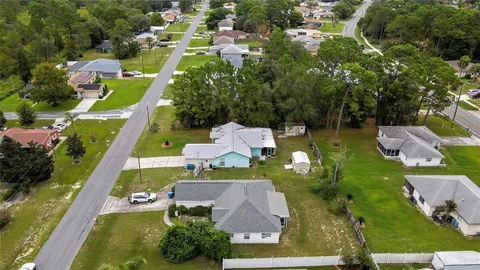 an aerial view of multiple houses with yard