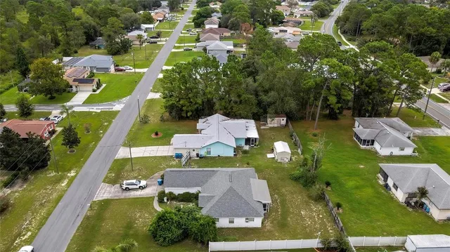 an aerial view of multiple houses with yard