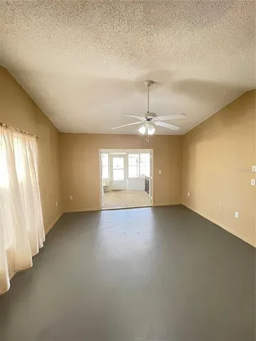 an empty room with a empty space and windows