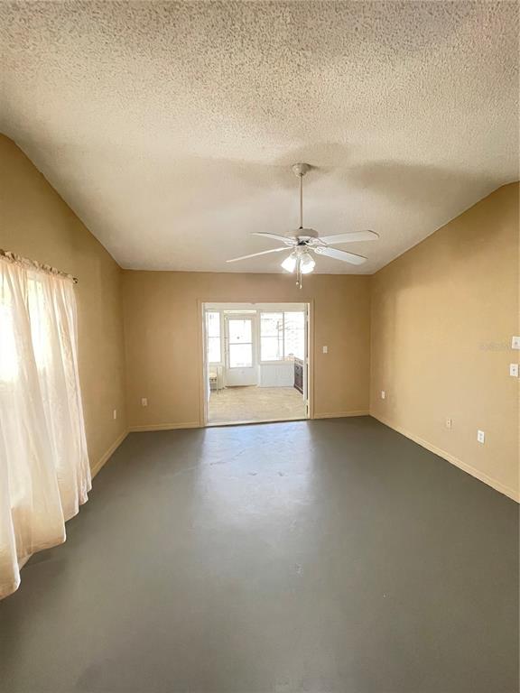 11322 Topaz Street Spring Hill, FL 34608 - Photo 7 of 41 an empty room with a empty space and windows