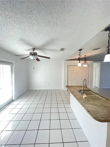 a view of a kitchen with a sink and cabinets