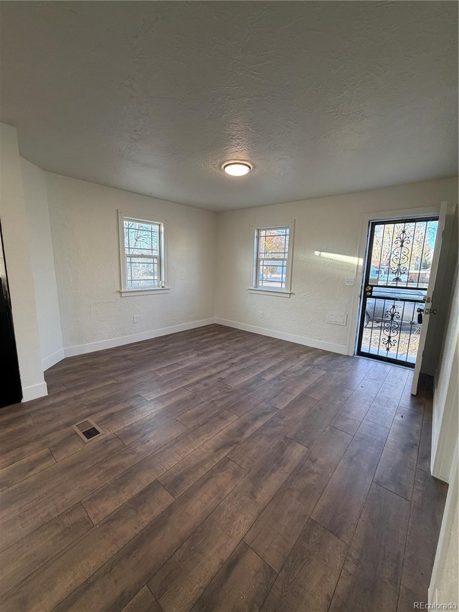 54 East Cornell Avenue Englewood, CO 80113 - Photo 2 of 10 a view of an empty room with a window and wooden floor