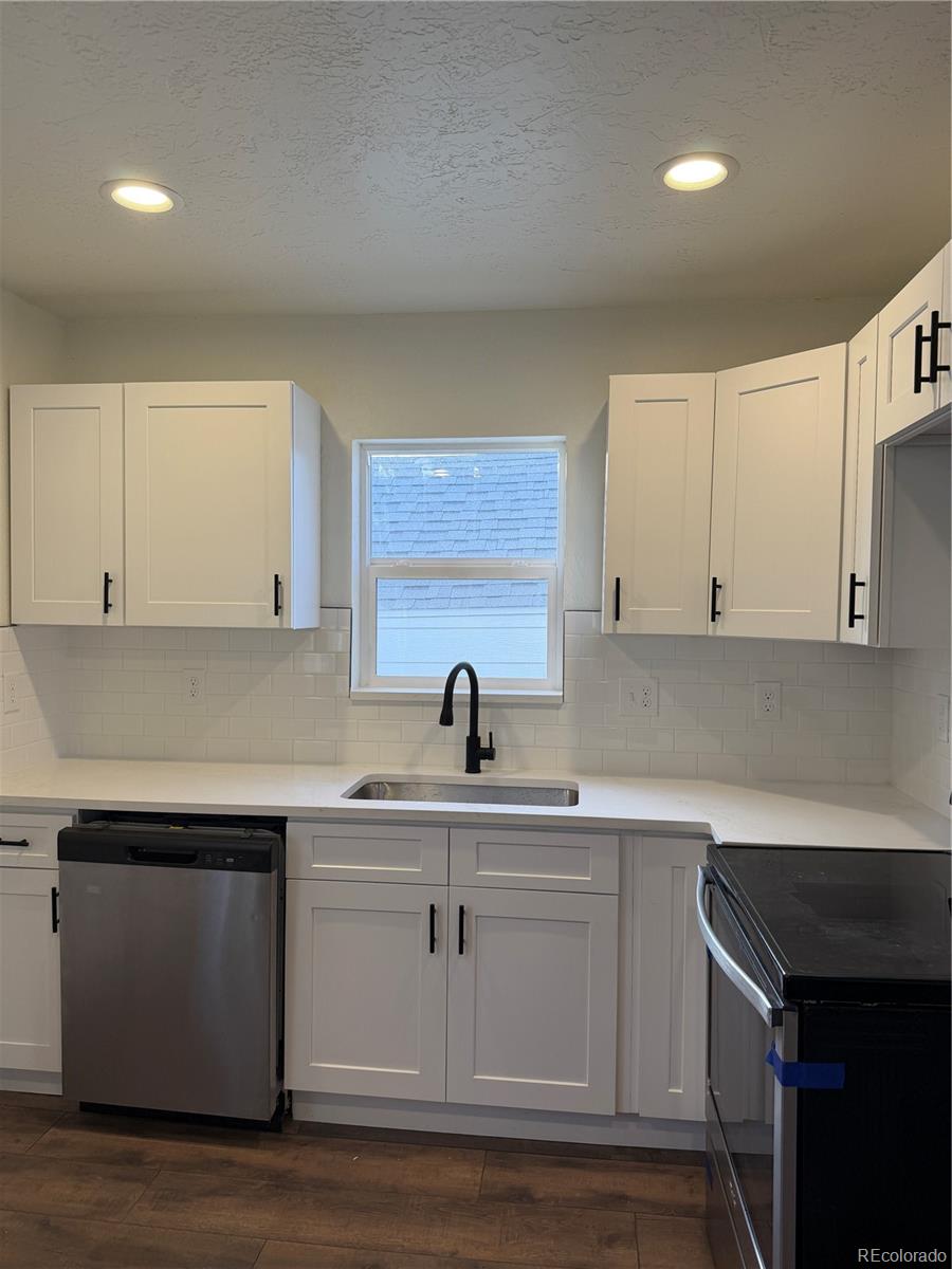 54 East Cornell Avenue Englewood, CO 80113 - Photo 4 of 10 a kitchen with white cabinets appliances and sink