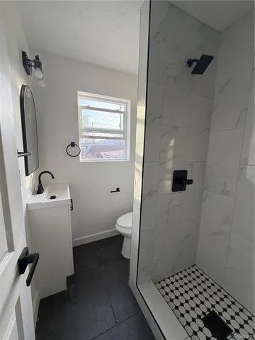 a bathroom with a sink toilet and shower