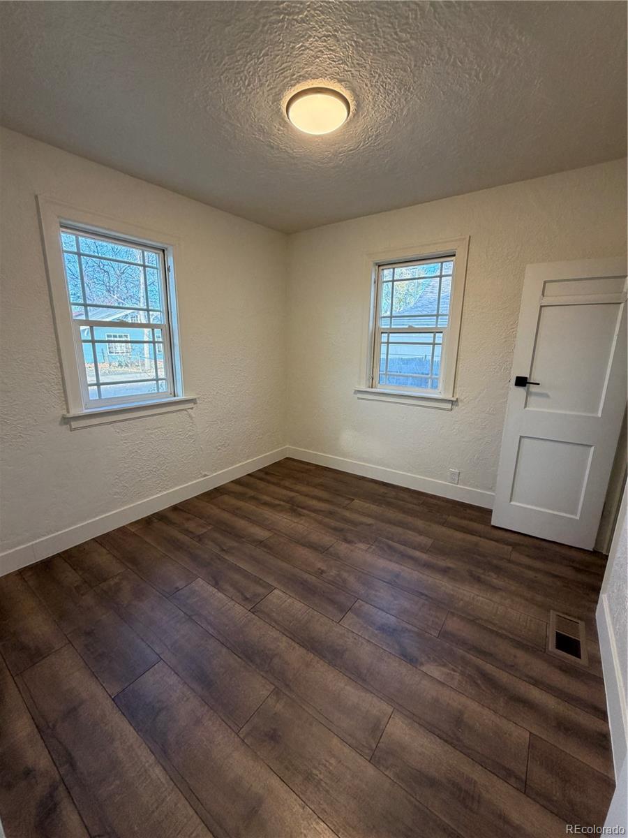 54 East Cornell Avenue Englewood, CO 80113 - Photo 6 of 10 a view of a room with wooden floor and window