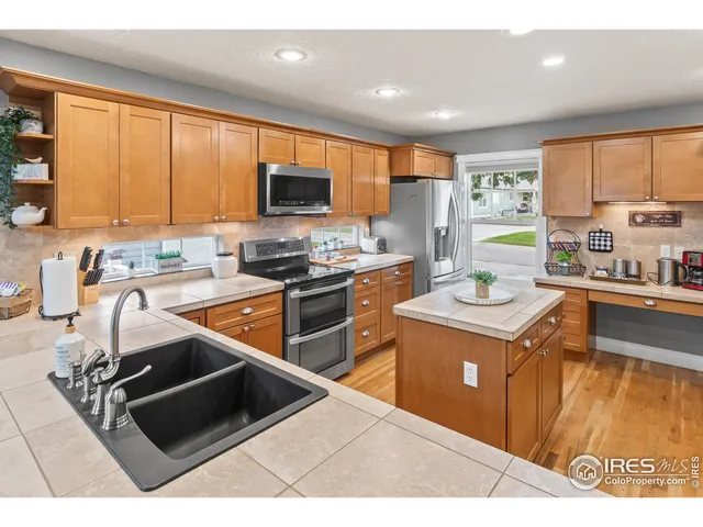 a spacious bedroom with a bed and a chandelier