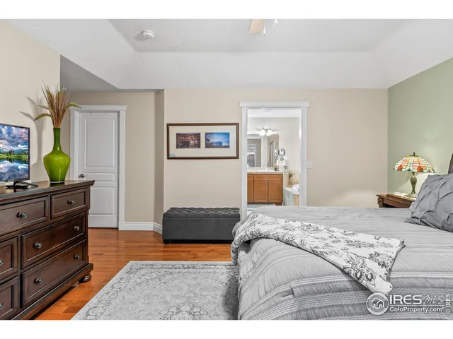 a bedroom with a bed next to a window with a bed