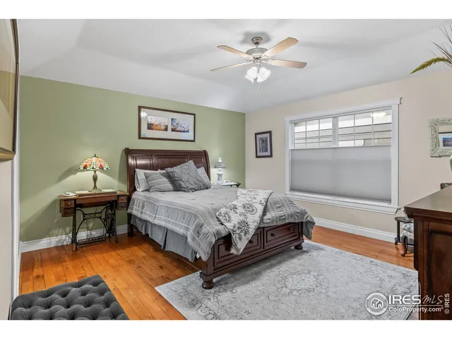 a bedroom with a bed chair and window