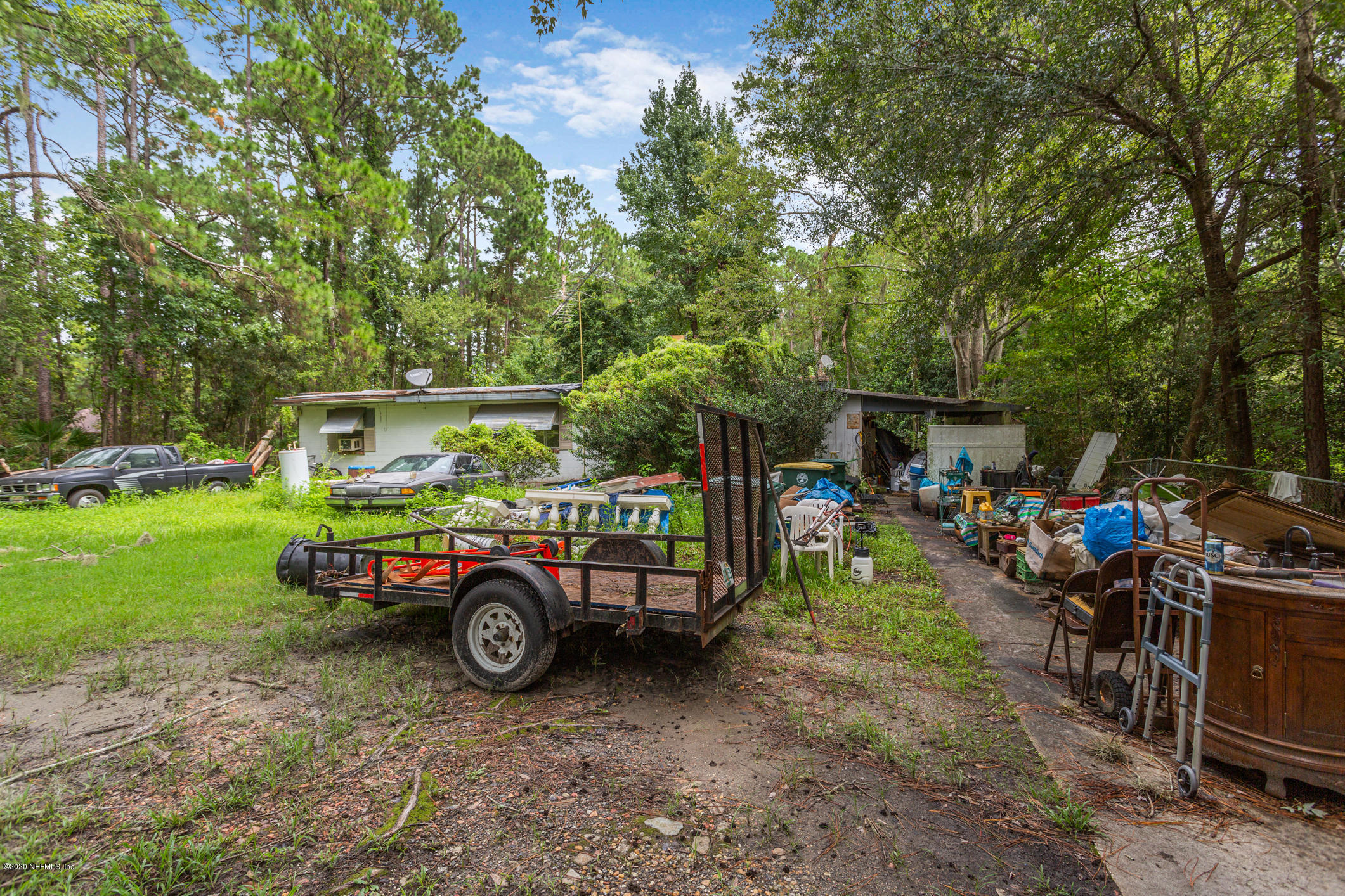 2837 Cortez Road Jacksonville, FL 32246 - Photo 3 of 16 a car parked in front of a house with a yard