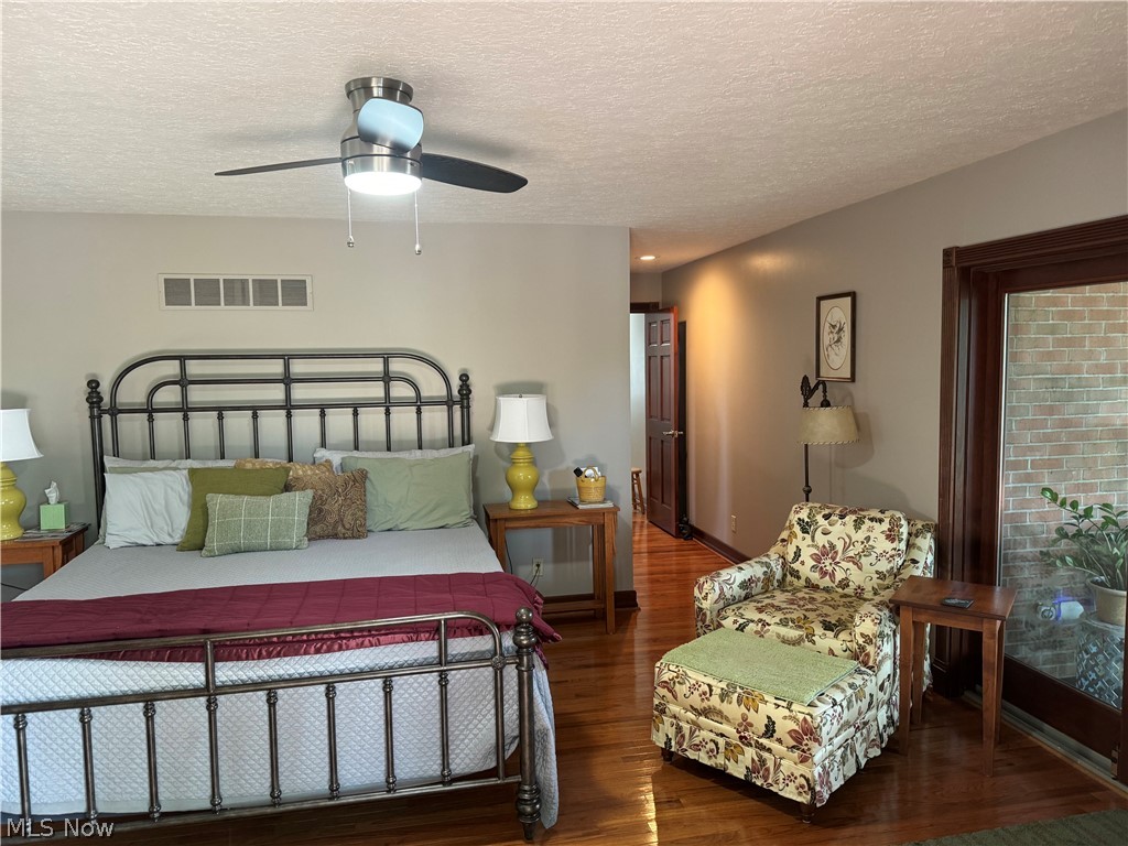 382 Riverview Acres Road Washington, WV 26181 - Photo 7 of 24 Bedroom with a textured ceiling, ceiling fan, and wood-type flooring