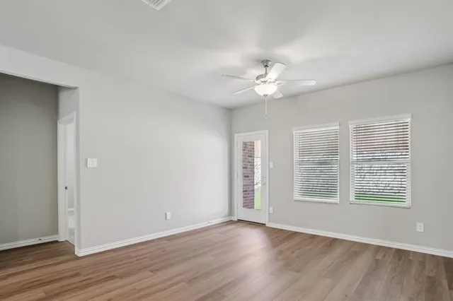 wooden floor in an empty room with a window