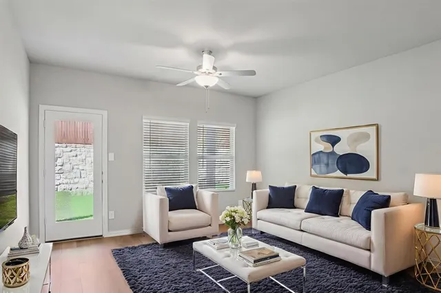 a living room with furniture and a large window