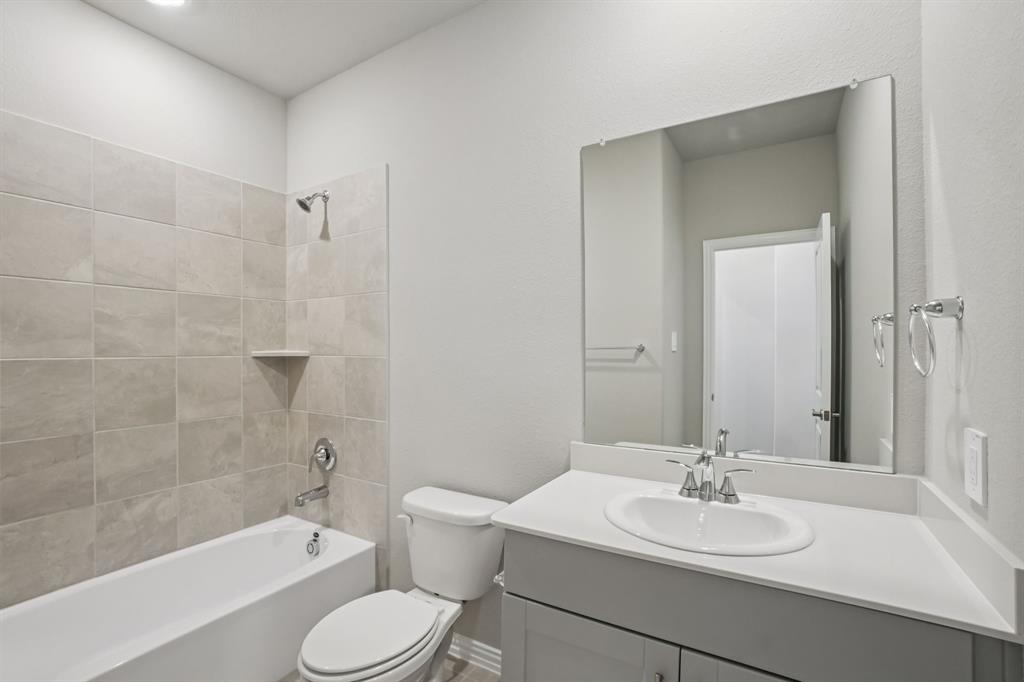 1725 Arches Road Anna, TX 75409 - Photo 16 of 28 a bathroom with a sink toilet and shower