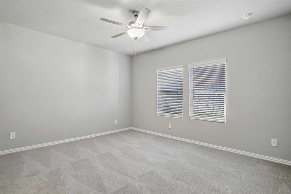 1725 Arches Road Anna, TX 75409 - Photo 22 of 28 an empty room with a window and a ceiling fan