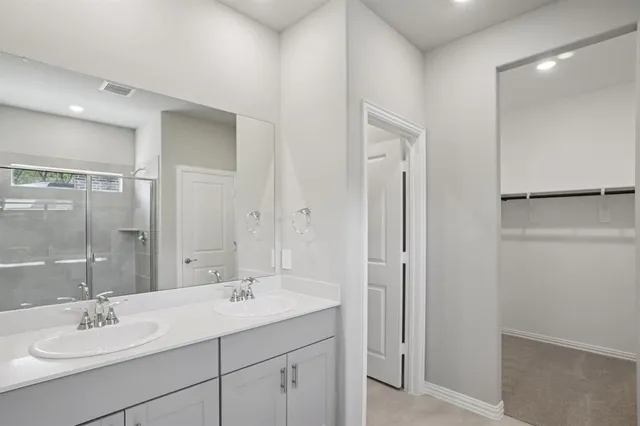 a bathroom with a sink double vanity and a mirror