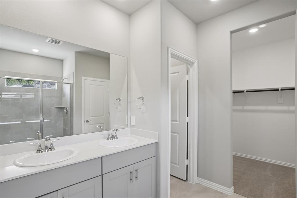 1725 Arches Road Anna, TX 75409 - Photo 25 of 28 a bathroom with a sink double vanity and a mirror