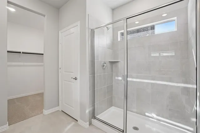 a bathroom with a glass shower door