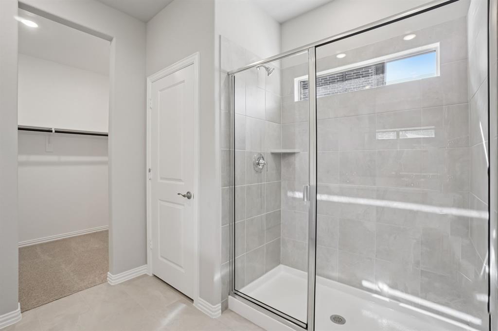 1725 Arches Road Anna, TX 75409 - Photo 26 of 28 a bathroom with a glass shower door