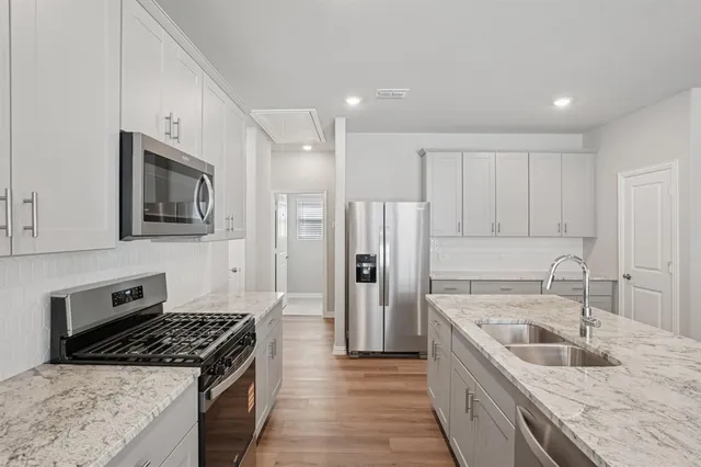 a kitchen with a sink stove and refrigerator