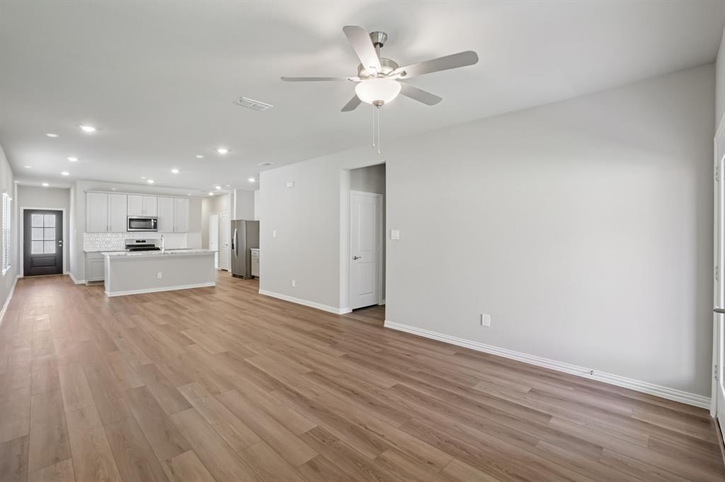 1725 Arches Road Anna, TX 75409 - Photo 8 of 28 a view of an empty room with wooden floor