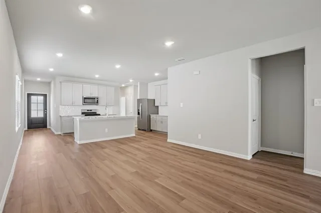a view of kitchen view wooden floor and kitchen