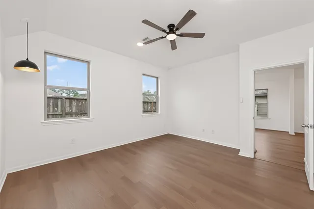 wooden floor in an empty room with a window