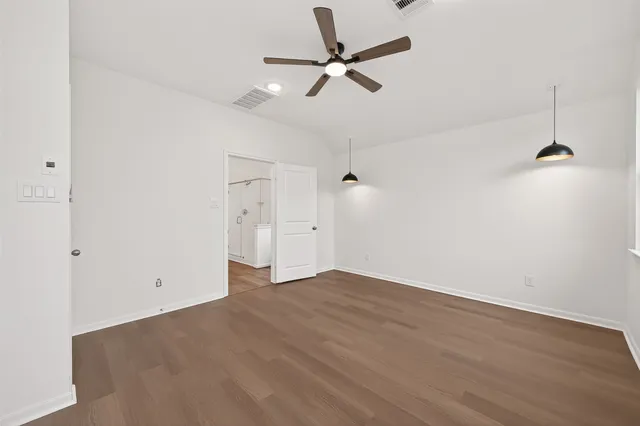 a view of an empty room with a ceiling fan