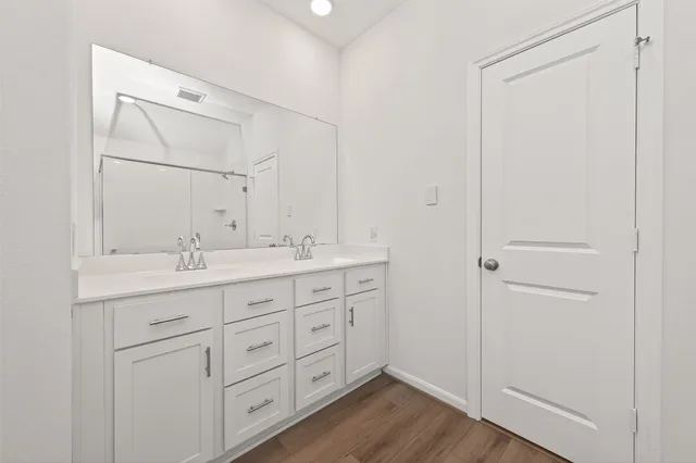 a bathroom with a double vanity sink and a mirror