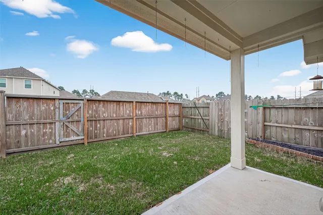 a view of a backyard with wooden fence