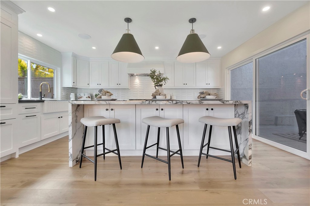 545 North Broadmoor Trail Orange, CA 92869 - Photo 23 of 75 a kitchen with stainless steel appliances a sink a stove a refrigerator and island with wooden floor