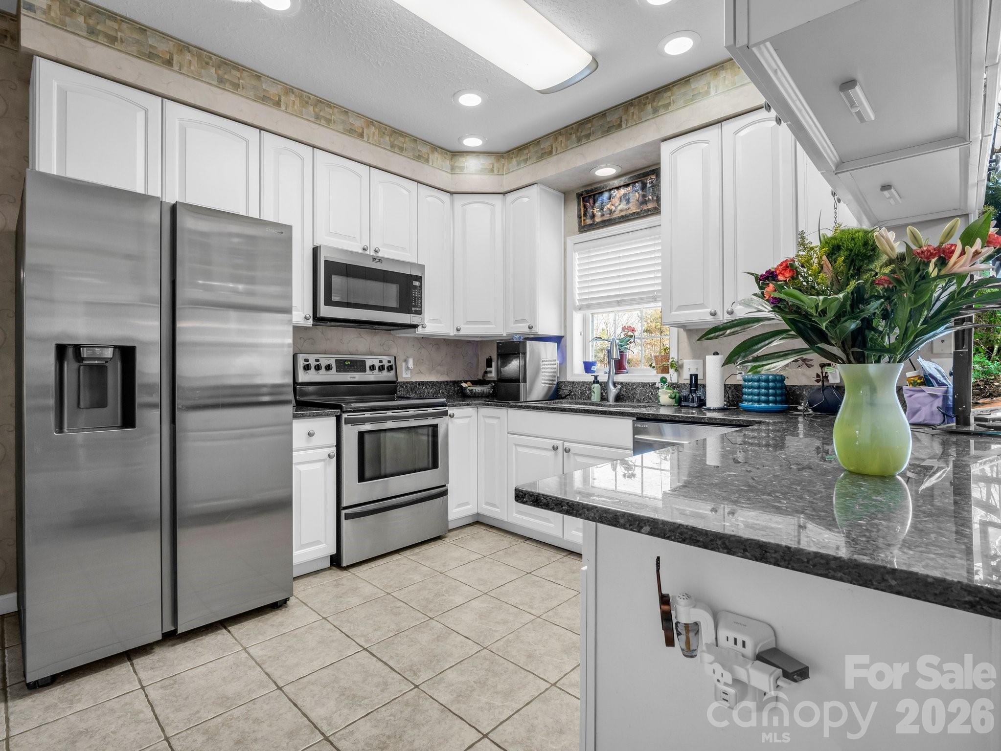 532 Harvey Logan Road Bostic, NC 28018 - Photo 29 of 48 a kitchen with granite countertop a refrigerator a stove and a sink