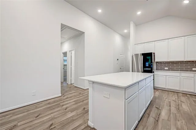 a kitchen with granite countertop a sink and a stove top oven