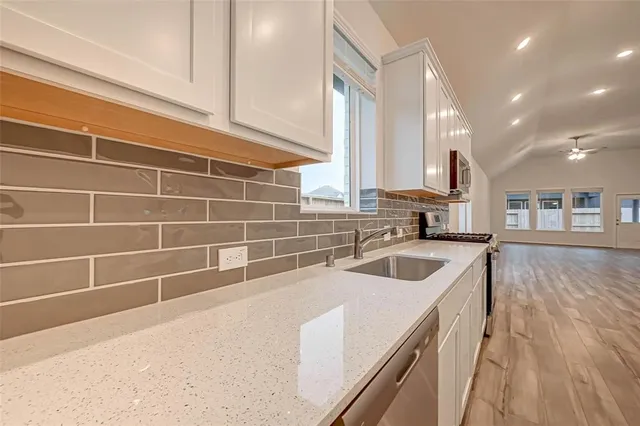 a kitchen with a sink and a refrigerator