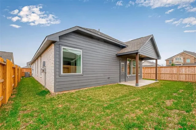 a view of a house with a yard and a garden