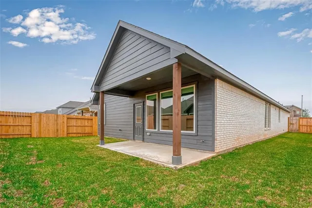 a front view of house with a garden