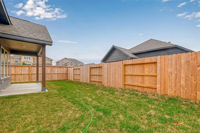 a view of a house with a backyard and a garden