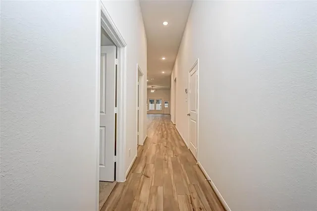 a view of a hallway with wooden floor