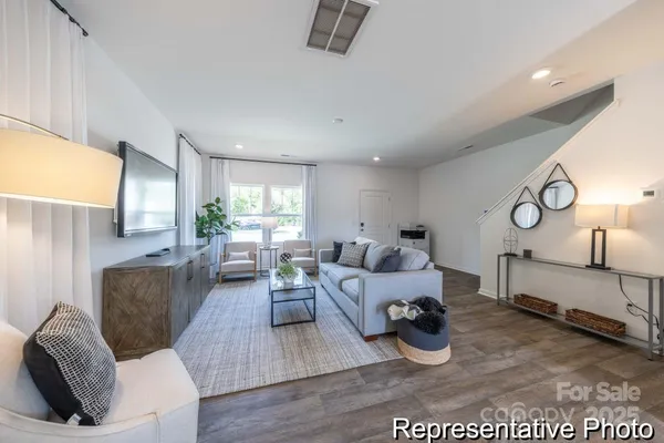 a living room with furniture window and wooden floor