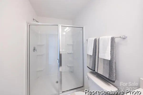 a bathroom with a glass shower door