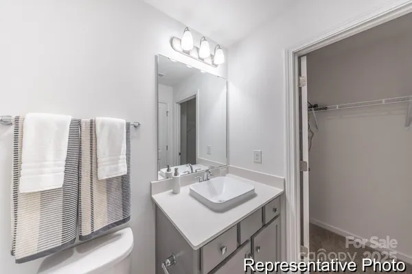 a bathroom with a sink vanity and a mirror