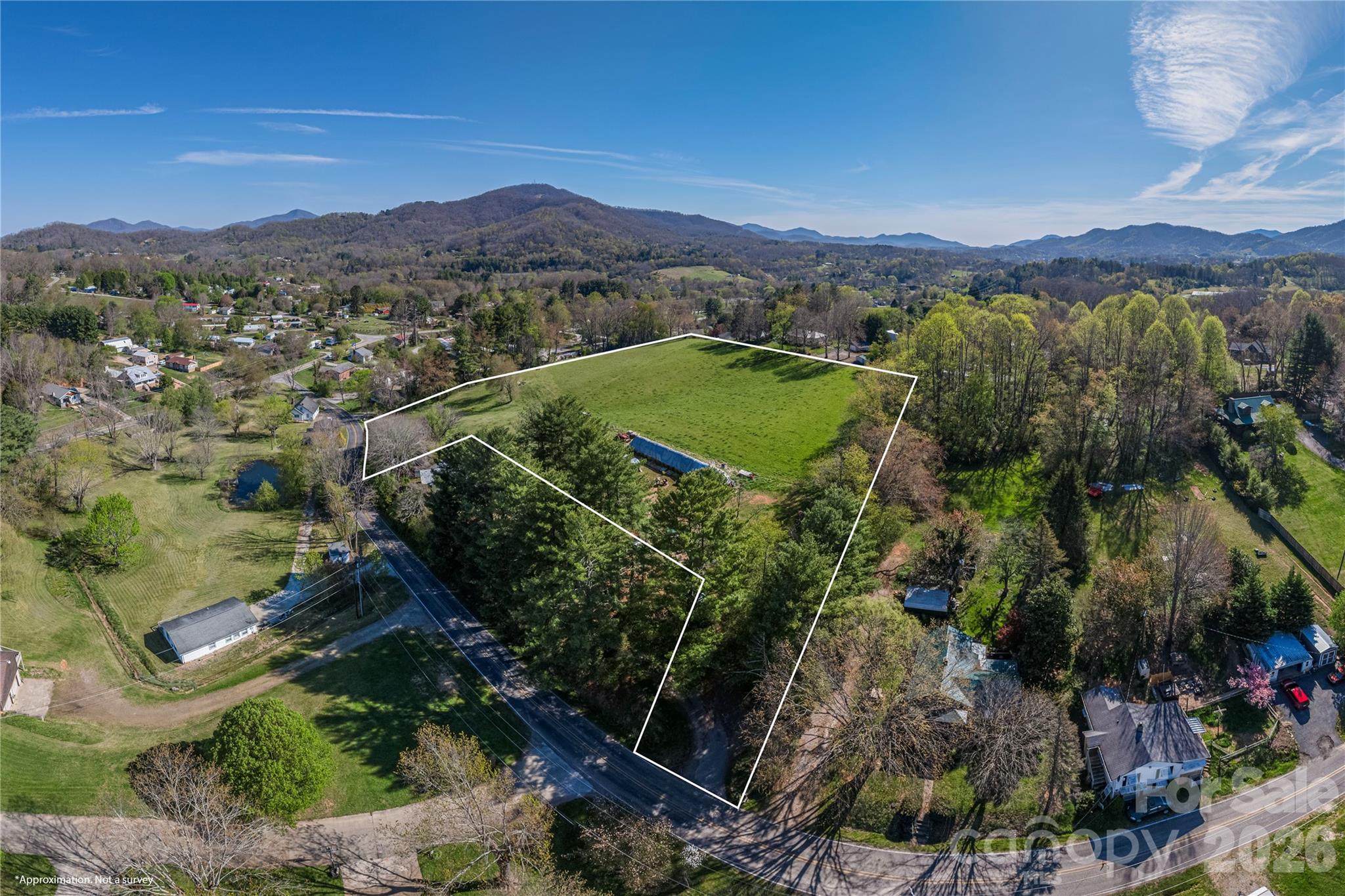 284 Woodland Church Road Clyde, NC 28721 - Photo 15 of 25 a view of a lush green hillside and a houses