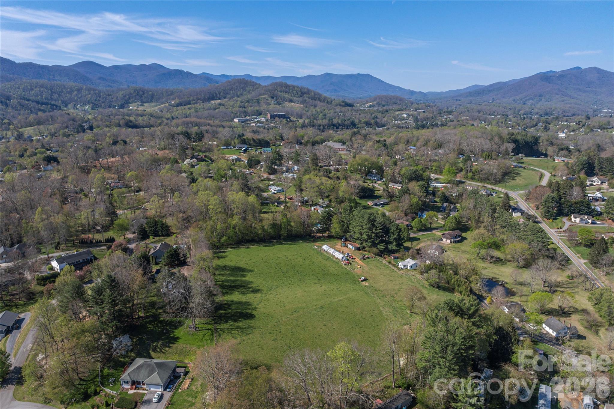 284 Woodland Church Road Clyde, NC 28721 - Photo 21 of 25 a view of a lush green hillside and houses