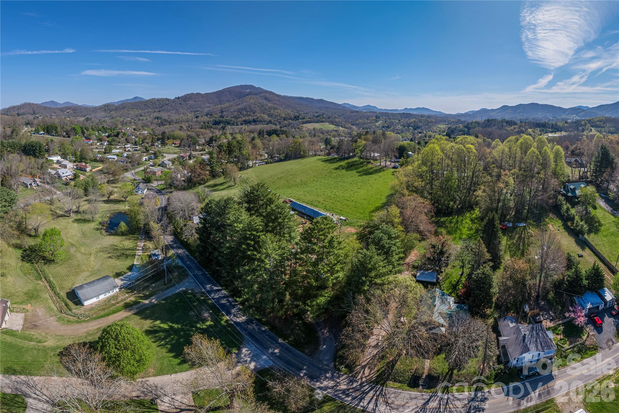 284 Woodland Church Road Clyde, NC 28721 - Photo 22 of 25 a view of a lush green hillside and a building in the background