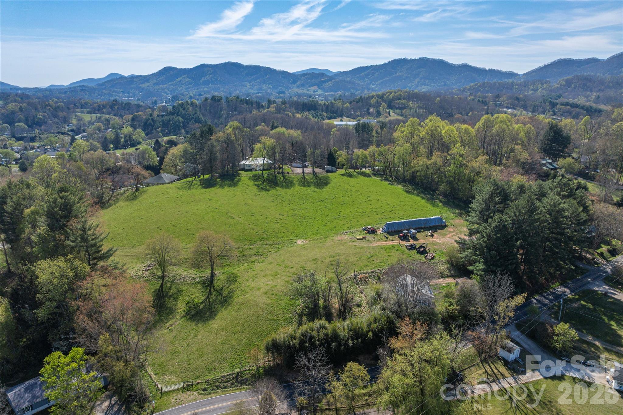 284 Woodland Church Road Clyde, NC 28721 - Photo 6 of 25 a view of a lush green hillside and houses