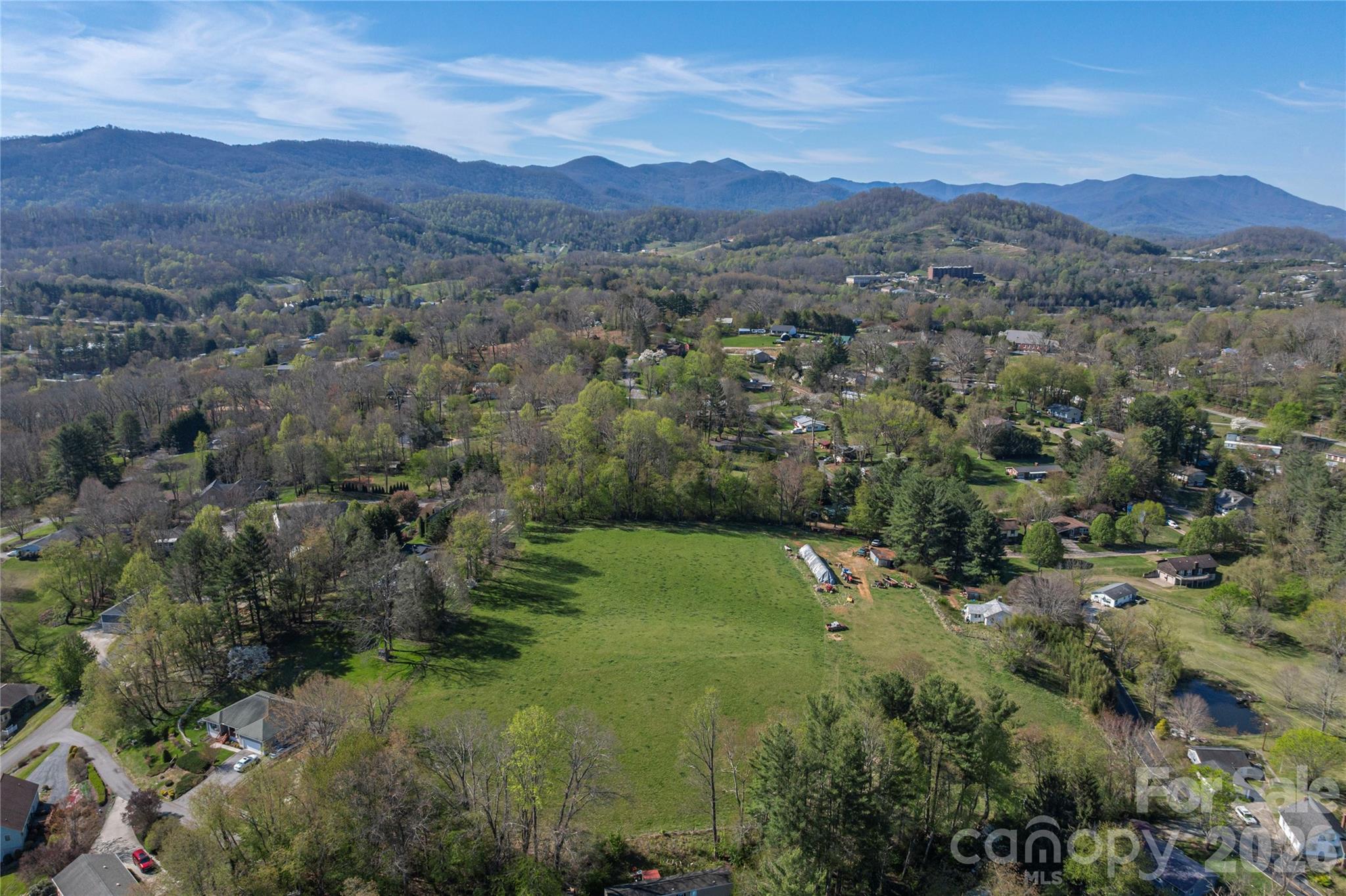 284 Woodland Church Road Clyde, NC 28721 - Photo 9 of 25 a view of a lush green hillside and houses