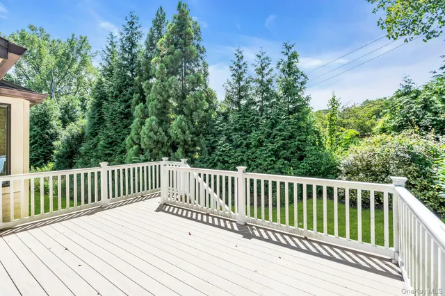 a view of wooden deck and a yard