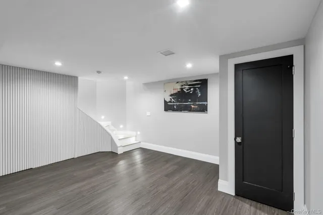 a view of empty room with wooden floor