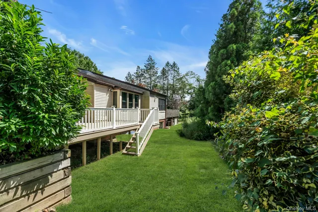 a house with green field in front of it