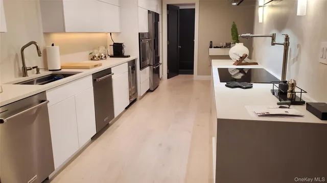 a kitchen with a sink appliances and cabinets
