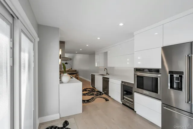 a kitchen with a sink stainless steel appliances and cabinets